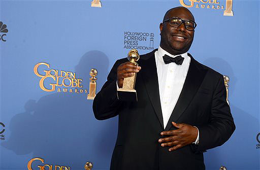 Steve McQueen poses in the press room with the award for best motion picture - drama for "12 Years a Slave" at the 71st annual Golden Globe Awards on Sunday.
