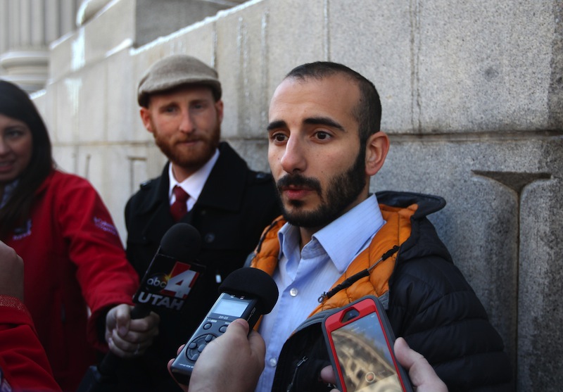 Derek Kitchen, left, and his partner Moudi Sbeity, right, talk with the media outside Frank E. Moss U.S. Courthouse following court on Dec. 4, 2013, in Salt Lake City. Since hundreds of same-sex couples already have married in Utah, there is no urgent need for the Supreme Court to intervene now in the legal battle, lawyers for gay couples told the justices Friday.