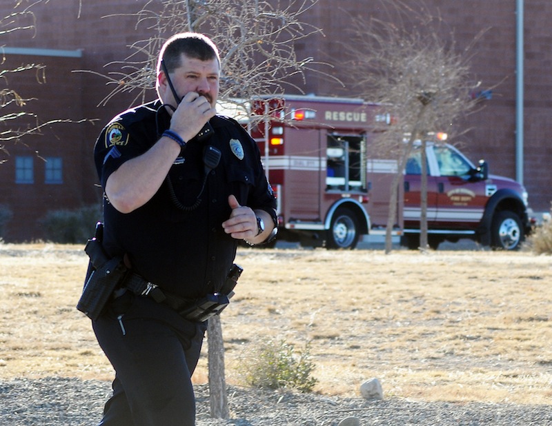 Law enforcement personnel set up a perimeter after a shooting at Berrendo Middle School, Tuesday, Jan. 14, 2014, in Roswell, N.M. A shooter opened fire at the middle school, injuring at least two students before being taken into custody.