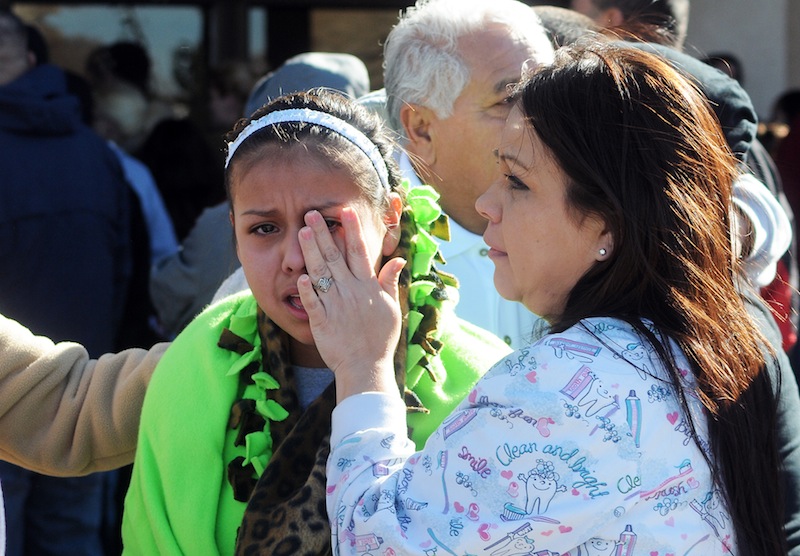 Students are reunited with families at a staging ground set up at the Roswell Mall following an early morning shooting at Berrendo Middle School in Roswell, New Mexico, Tuesday, January 14, 2014.