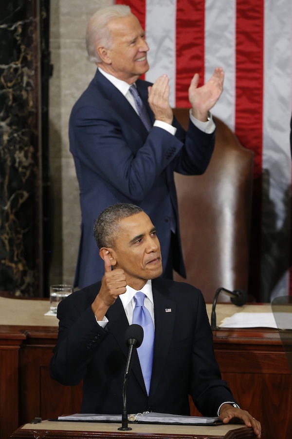 President Barack Obama gives a thumbs-up and Vice President Joe Biden applauds Army Ranger 1st Class Cory Remsburg during the president's State of the Union address on Capitol Hill in Washington, Tuesday Jan. 28, 2014.