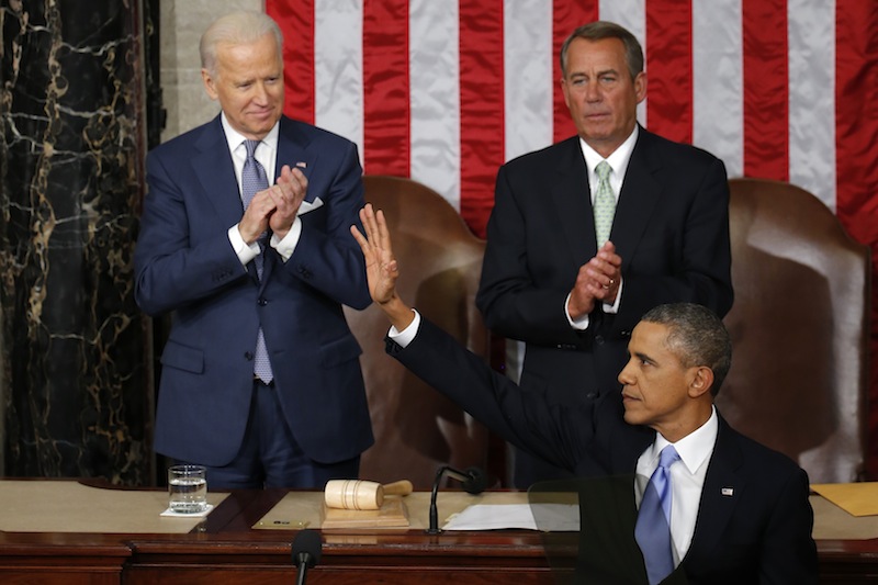 President Barack Obama waves after giving his State of the Union address on Capitol Hill in Washington, Tuesday Jan. 28, 2014. Vice President Joe Biden and House Speaker John Boehner of Ohio applaud.