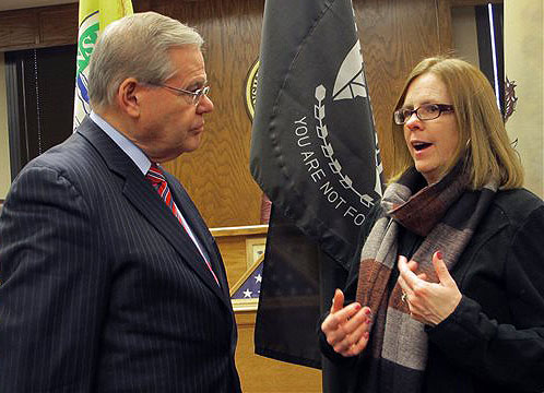U.S. Sen Robert Menendez listens to Peggy Molloy, who fears that skyrocketing flood insurance premiums will force her from her Point Pleasant, N.J., home, Thursday. The two spoke at a Jan. 2 public hearing on a bill by the Democratic senator to delay flood insurance rate hikes by up to two years while the federal government studies their affordability.