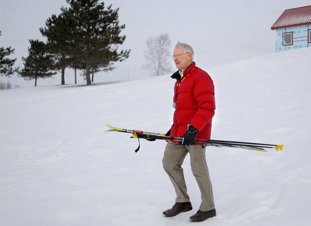 Bob Sprague, a retired ski coach and teacher in Caribou, walks near trails where he used to help train Russell Currier. “You watched him and you knew,” he said of Currier.
