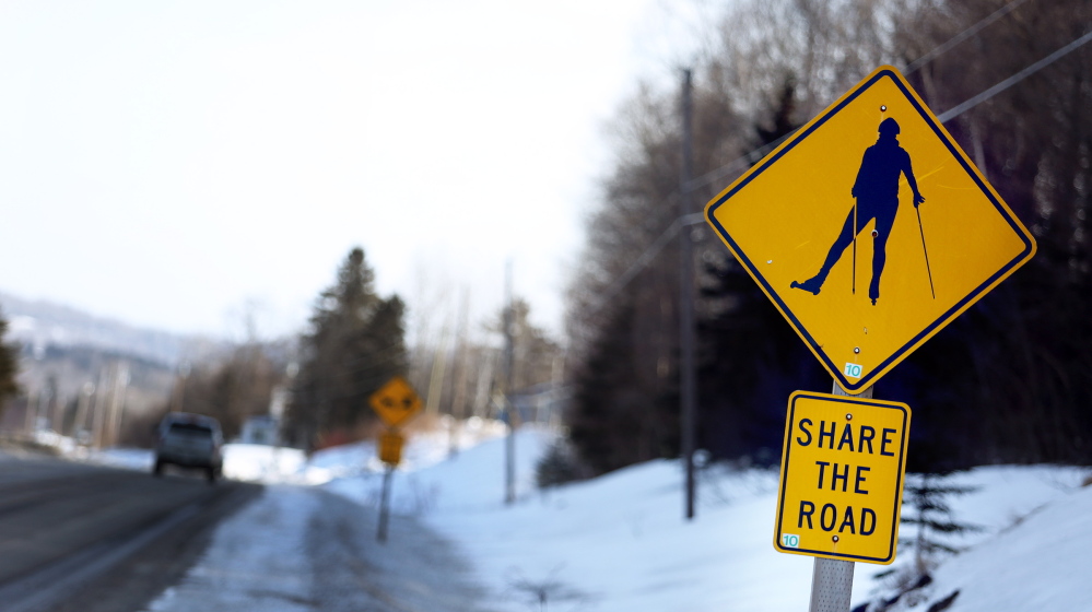 A sign alerts motorists to the likelihood of roller skiers along a road in Presque Isle, where the Maine Winter Sports Center has a world-class training facility. Such signs are commonplace in Aroostook County, where Olympian biathlete Russell Currier was raised.