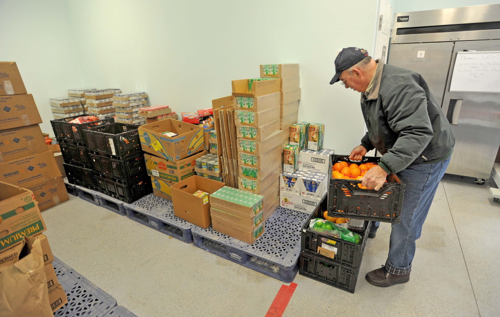 Volunteering: Kerry Temple, a volunteer with the Waterville Area Food Bank delivers goods to the United Methodist Church on Pleasant Street in Waterville on Friday.
