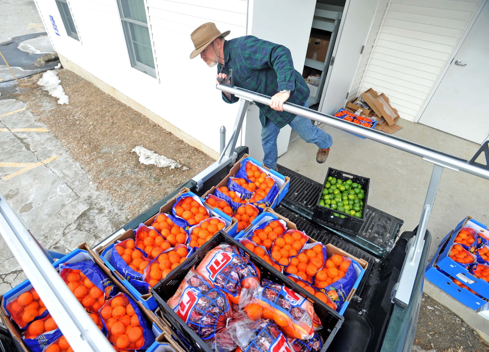 Delivery: Dave Dawson with the Waterville Area Food Bank delivers goods to the United Methodist Church on Pleasant Street in Waterville on Friday.