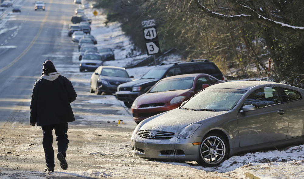 Abandoned cars sit idle along Northside Parkway in Atlanta on Thursday. State agencies including Georgia State Patrol, National Guard and Georgia Department of Transportation (GDOT) HEROs started using four-wheel-drive vehicles to transport motorists back to their vehicles from two metro Atlanta locations.