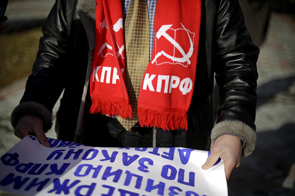Igor Vasiliyev, head of the local branch of the Communist Party, wears a scarf decorated with a hammer and sickle, a symbol of the communist movement, as he leads a protest in the 50 Years of Victory in the Great Patriotic War Park to hold the first official demonstration in the designated Olympic protest area for the 2014 Winter Olympics on Saturday in Sochi, Russia. The protestors were members of the local branch of the Communist Party demonstrating for government benefits for Russian children of World War II born between 1928 and 1945.