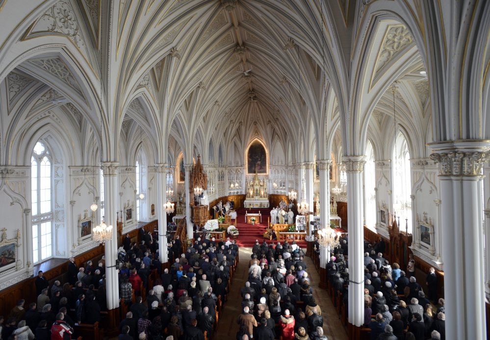 People attend a memorial service at the St. Jean Baptiste church in memory of the victims of last weeks seniors’ residence fire on Saturday in L’Isle-Verte, Quebec.