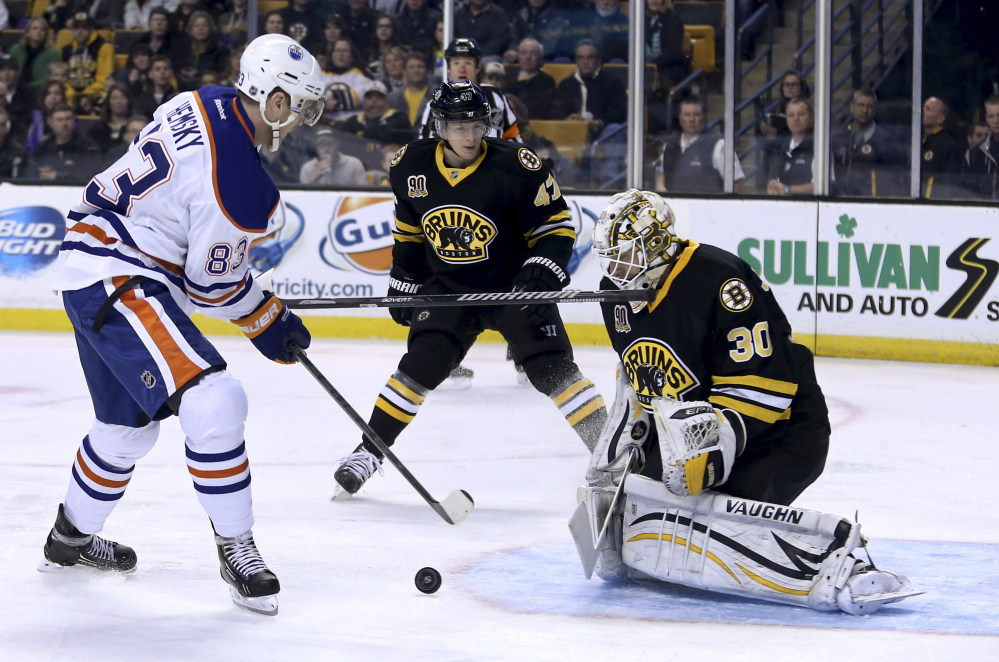 Bruins goalie Chad Johnson makes the save on a shot by Edmonton’s Ales Hemsky as Bruins defenseman Torey Krug loses his stick in the first period Saturday.