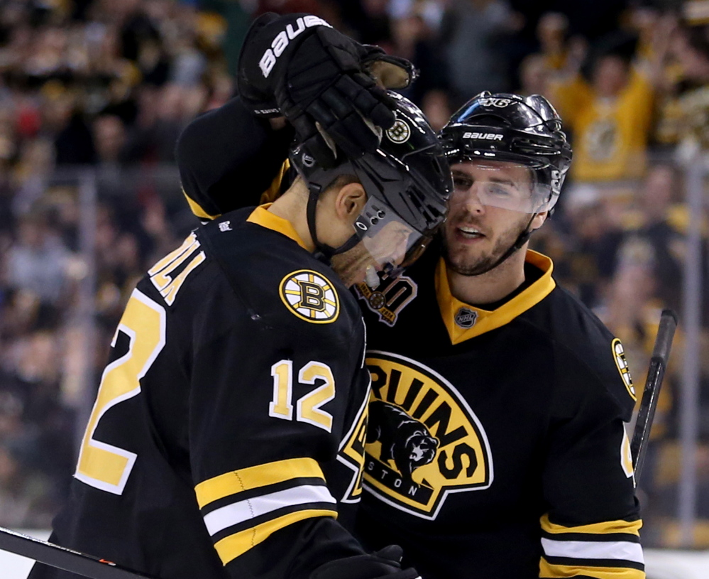 David Krejci, right, is congratulated by Jarome Iginla after scoring a second-period goal Saturday against the Edmonton Oilers at Boston. The Bruins won, 4-0.