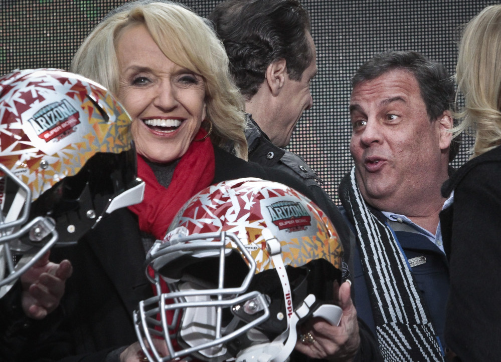 Arizona Gov. Jan Brewer, left, react for photos as New York Gov. Andrew Cuomo, center, and New Jersey Gov. Chris Christie, right, leave after a ceremony to pass official hosting duties of next year’s Super Bowl to Arizona on Saturday.