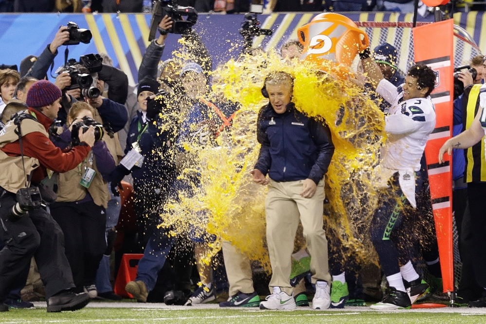 Seattle Seahawks head coach Pete Carroll is doused with Gatorade late in the second half of the NFL Super Bowl XLVIII football game Sunday, Feb. 2, 2014, in East Rutherford, N.J. The Seahawks won 43-8.