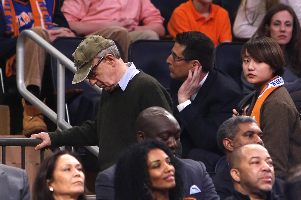 Filmmaker Woody Allen, left, leaves late in the fourth quarter of Saturday’s Knicks game at Madison Square Garden. Dylan Farrow renewed molestation allegations against Allen, claiming he sexually assaulted her when she was 7 after he and actress Mia Farrow adopted her.