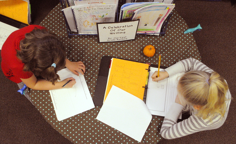 Erica Belz, left, and Faith DiFazio sketch as they start a story during a writing workshop last fall in Jessica Gurney’s classroom at Manchester Elementary School.