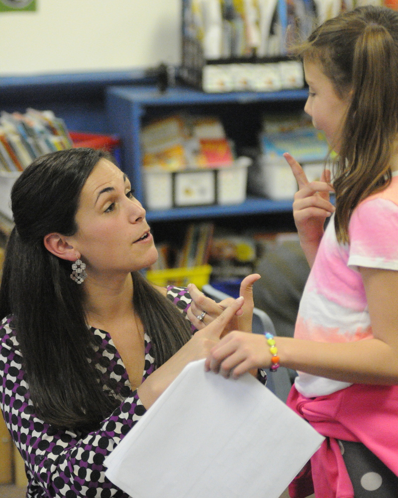Jessica Gurney, left, talks with Grace Leach during a writing workshop last fall at Manchester Elementary School.