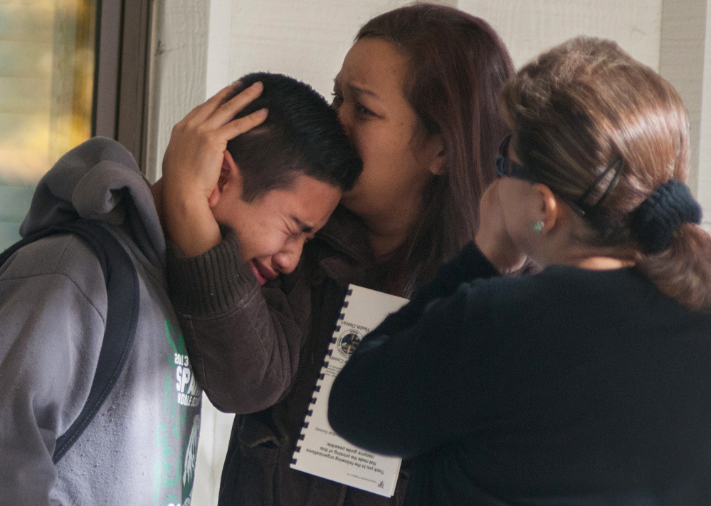 A Sparks Middle School student is comforted as he cries after being released from Agnes Risley Elementary School, where some students were evacuated to after a shooting, in Sparks, Nev., on Oct. 21, 2013. Although still relatively rare, there’s been no real reduction in the number of school shootings since security was beefed up around the country after the rampage at Connecticut’s Sandy Hook Elementary School in December 2012.