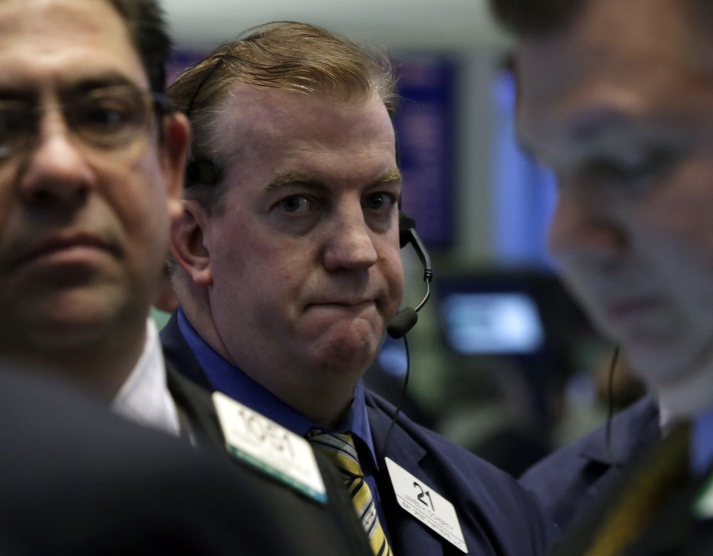 Traders work on the floor of the New York Stock Exchange on Friday, when markets ended the worst January since 2009.