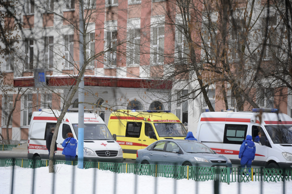 Ambulances are parked Monday at an entrance to a school in Moscow, Russia, where police said an armed teenager burst into the school and killed a security guard and a teacher before being taken into custody.