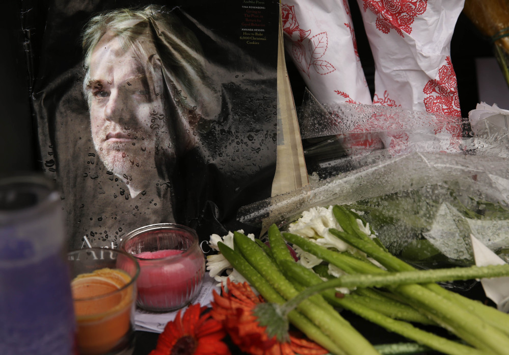 A makeshift memorial is seen Monday outside the building where the body of actor Philip Seymour Hoffman was found in New York.