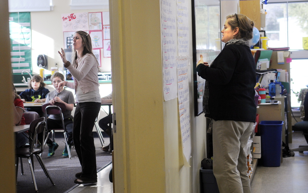 CRUNCH: Fourth grade teachers Gretchen Nickerson, left, and Sarah Hanley instruct in a room at Helen Thompson School in West Gardiner that is divided by a temporary wall. Nickerson teaches in the former life skills space while Hanley uses the former art studio for their classrooms.