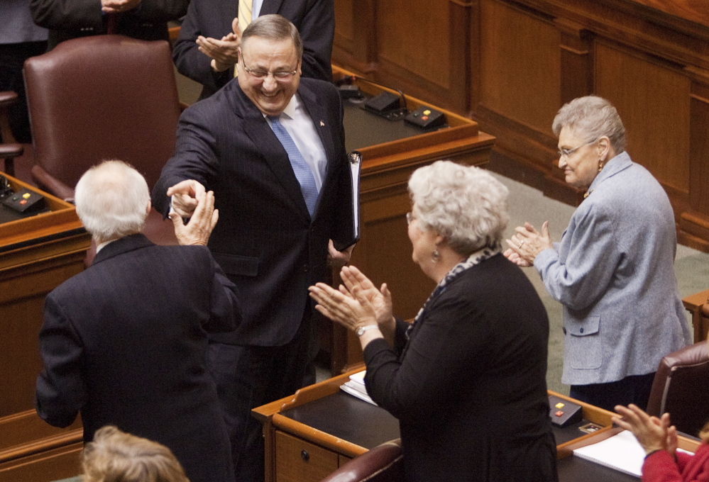 Governor Paul LePage jokes with Rep James J. Campbell, I-Newfield, while heading down the aisle to deliver his State of the State Address in the House Chambers at the State House in Augusta on Tuesday February 4, 2014.