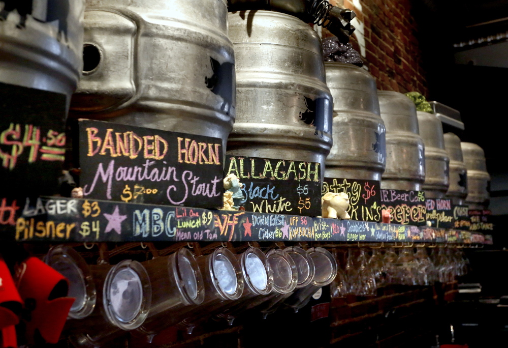 Kegs, the contents of which are described by a sign, line the wall at the The Thirsty Pig in Portland. A 1937 state law prohibits the posting of alcohol content for beers.