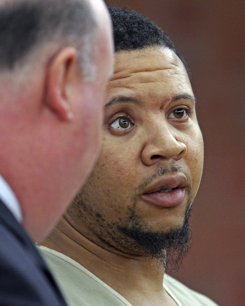 Alexander Bradley listens to his attorney Robert Pickering, left, during arraignment on weapons charges Tuesday in Superior Court in Hartford, Conn. Bradley was shot in the leg outside a Hartford nightclub Sunday night, where police said he returned gunfire.