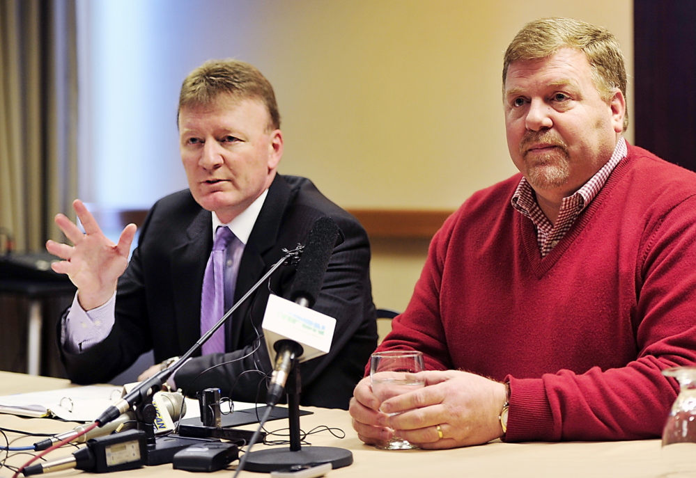 Neal Pratt, left, chair of the board of trustees of the Cumberland County Civic Center, and Ron Cain, majority owner of the Portland Pirates, announce the signing of a five-year contract Tuesday for the Pirates to play at the civic center.