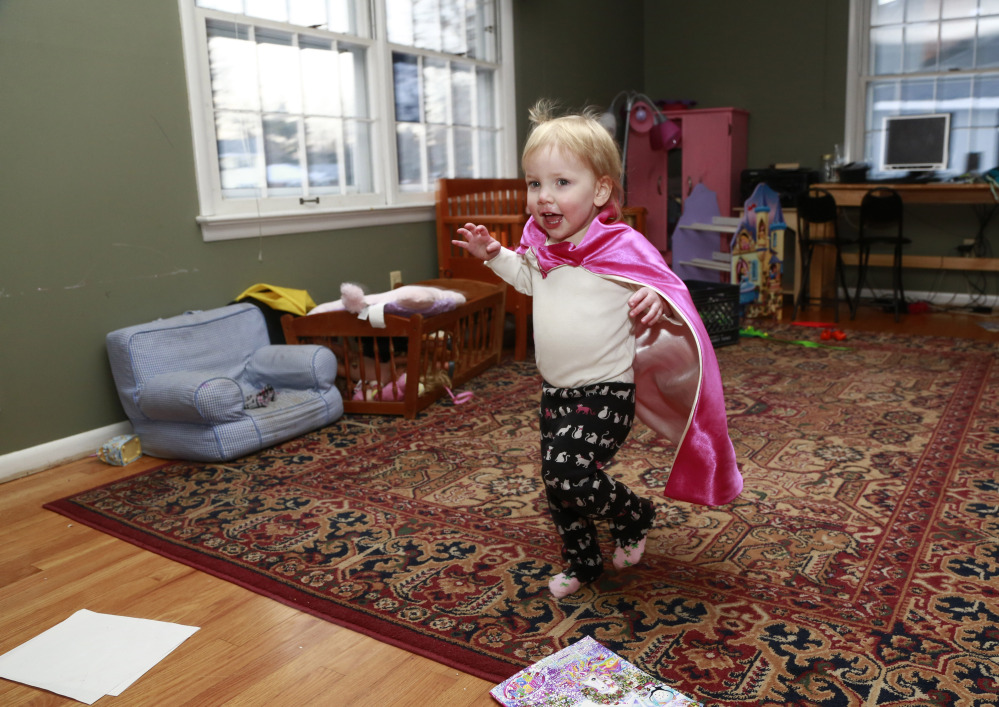Felicity Beck-Kehoe runs through the family home of her parents Mike Beck and Joanne Kehoe as the family tries to combat cabin fever Monday in Indianapolis.