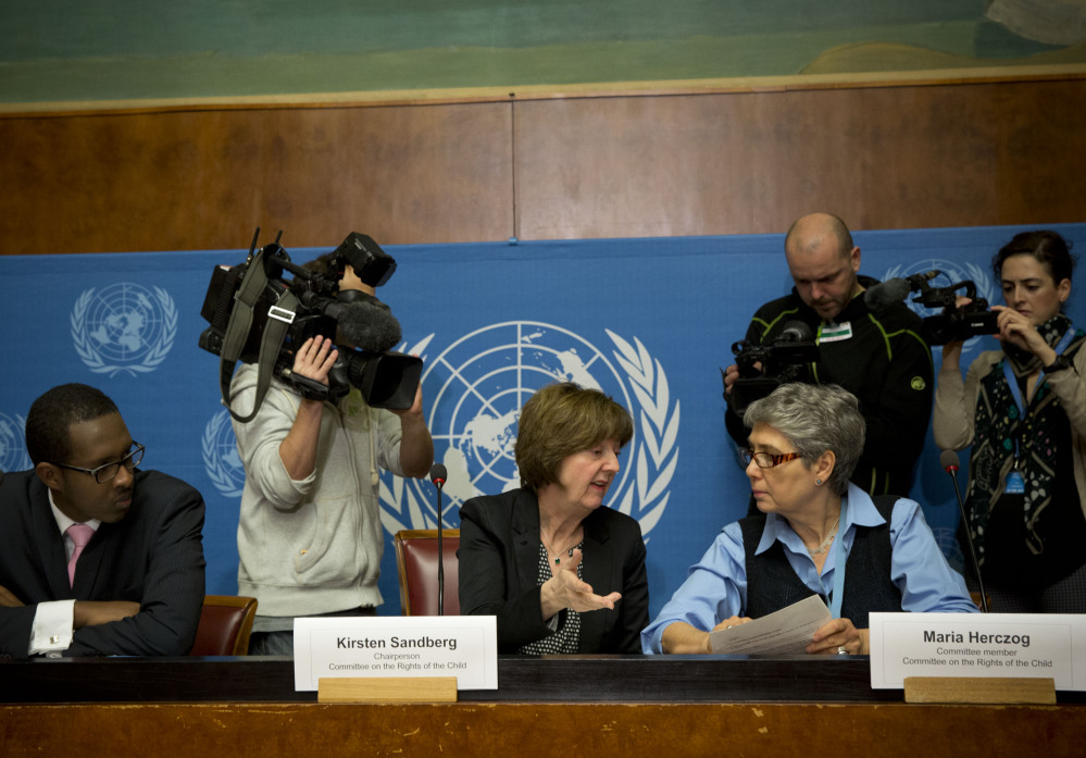 Kirsten Sandberg, center, chairperson of the U.N. Committee on the Rights of the Child, talks to committee members Maria Herczog, right, and Benyam Mezmur during a news conference at the United Nations headquarters in Geneva, Switzerland, on Wednesday. The committee denounced several Vatican policies.