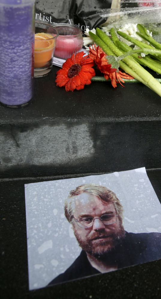 A makeshift memorial is seen Monday outside the New York building where the body of Philip Seymour Hoffman was found.
