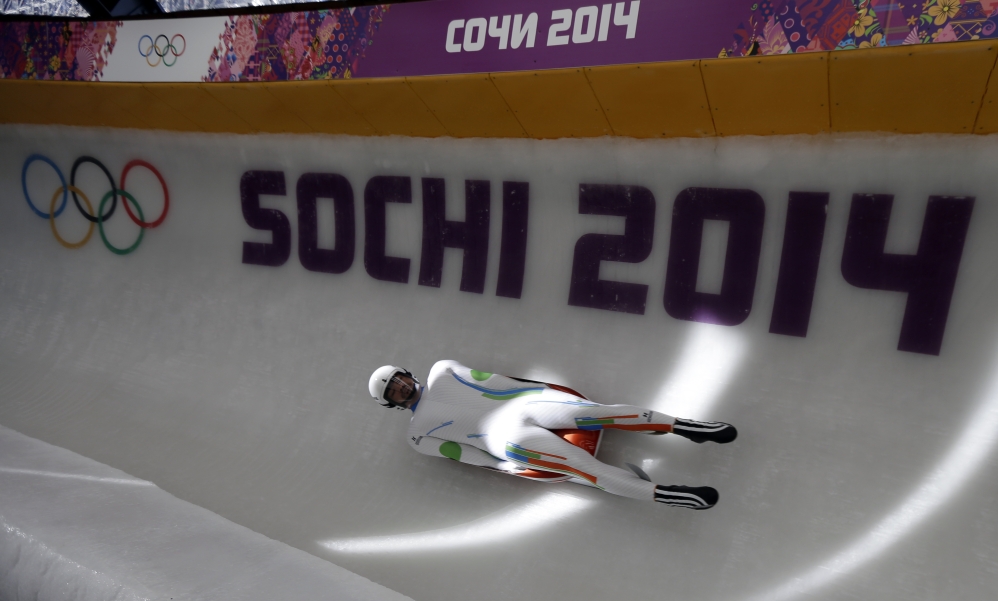 Shiva Keshavan, who is from India but competing under the Olympic Flag, completes a practice run in the men's luge singles at the 2014 Winter Olympics, Tuesday, Feb. 4, 2014, in Krasnaya Polyana, Russia. Keshavan is competing in his fifth Olympics and cannot represent India because his nation is under international sanctions. (AP Photo/Natacha Pisarenko)