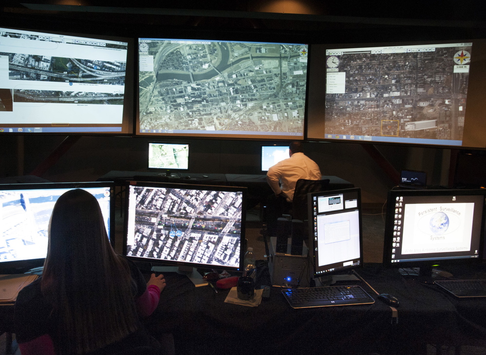 A Persistent Surveillance Systems analyst at the company’s command center in Dayton, Ohio, checks over multiscreen video footage of traffic patterns.