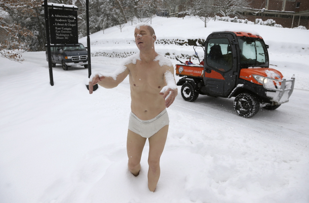 A statue of a man sleepwalking in his underwear is surrounded by snow on the campus of Wellesley College on Wednesday. The sculpture entitled “Sleepwalker” is part of an exhibit by sculptor Tony Matelli at the college’s Davis Museum.