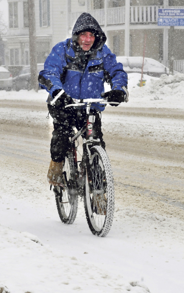 TWO-WHEEL DRIVE: Danny Hawes manages to keep his bike upright while pedaling in Fairfield on a snowy Wednesday. “The traction is not good today,” Hawes said.