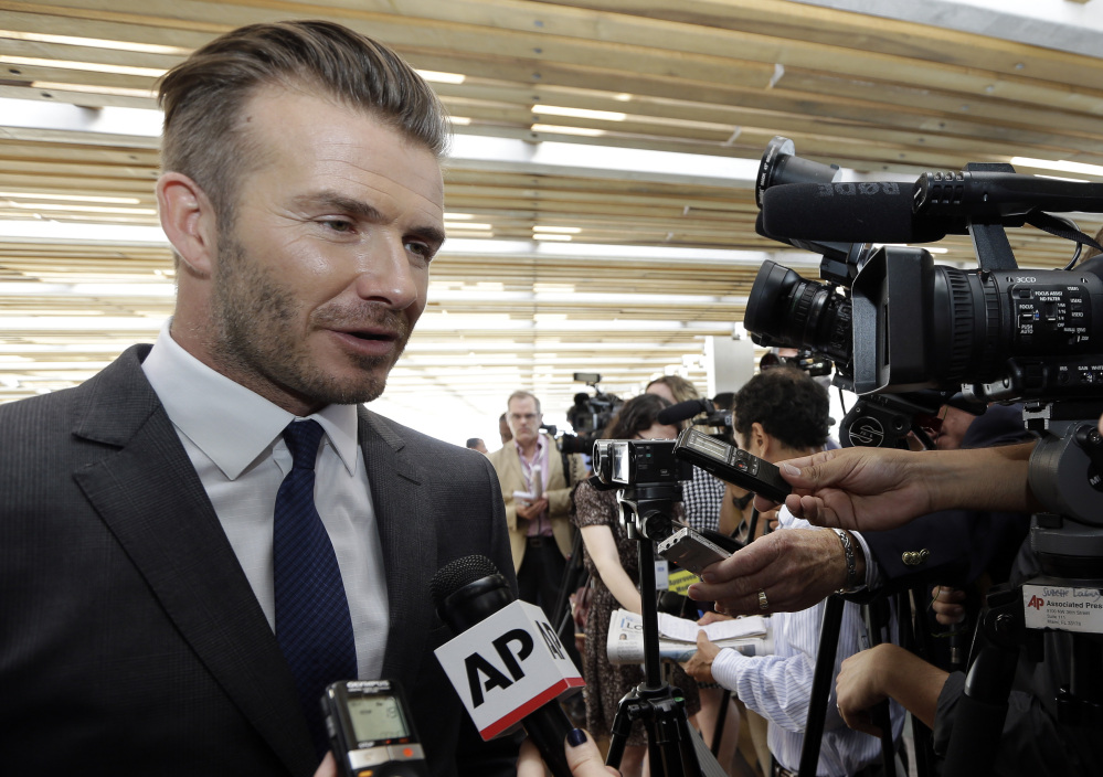 SOUTH BEACH SOCCER: Former England soccer star David Beckham responds to a question following a news conference where he announced Wednesday he will exercise his option to purchase a Major League Soccer expansion team in Miami.