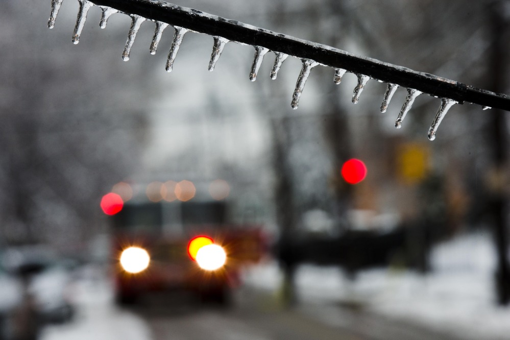 An ice-covered utility line blocks the path of a firetruck after a storm on Wednesday in Philadelphia. Icy conditions have knocked out power to more than 200,000 electric customers in southeastern Pennsylvania.