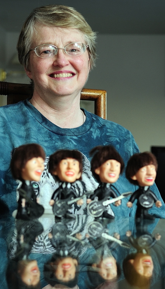 Staff photo by Joe Phelan FOND MEMORIES: Cindy Masiero, of China, still has the set of Beatles dolls she got as a child.