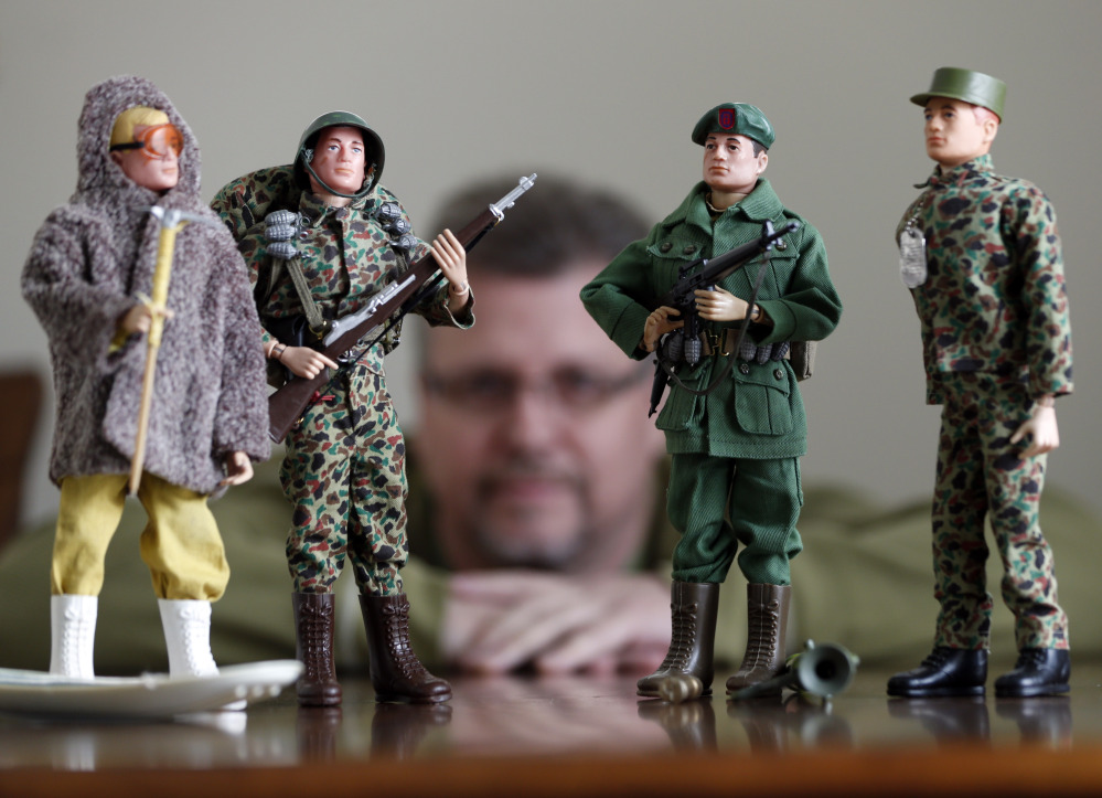 Tearle Ashby poses with some of his G.I. Joe action figures in Niskayuna, N.Y.