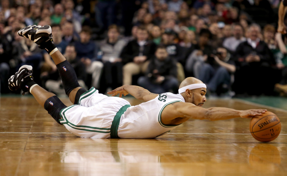 Boston Celtics point guard Jerryd Bayless dives for a loose ball during the first half against the Sacramento Kings on Friday in Boston.