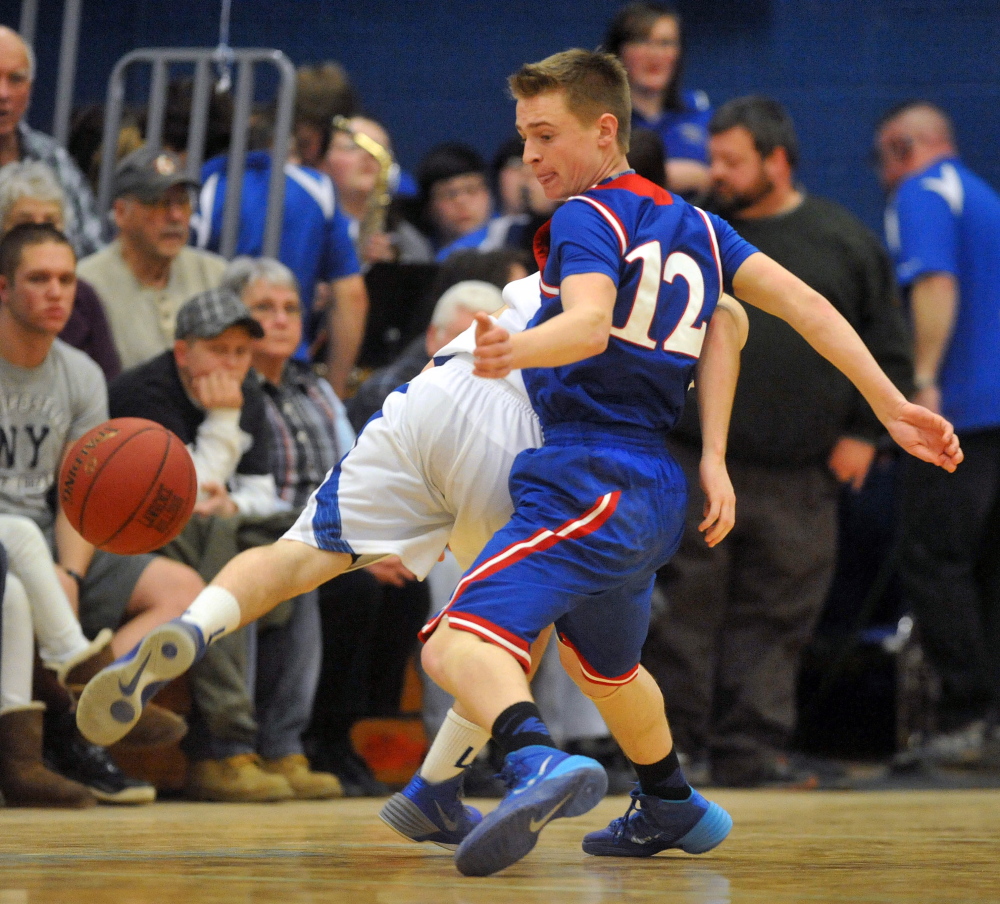 Staff photo by Michael G. Seamans Messalonskee High School's Spencer Bishop, 12, steals the ball from Lawrence High School's J.T. Nutting, 2, at Lawrence High School in Fairfield on Friday.