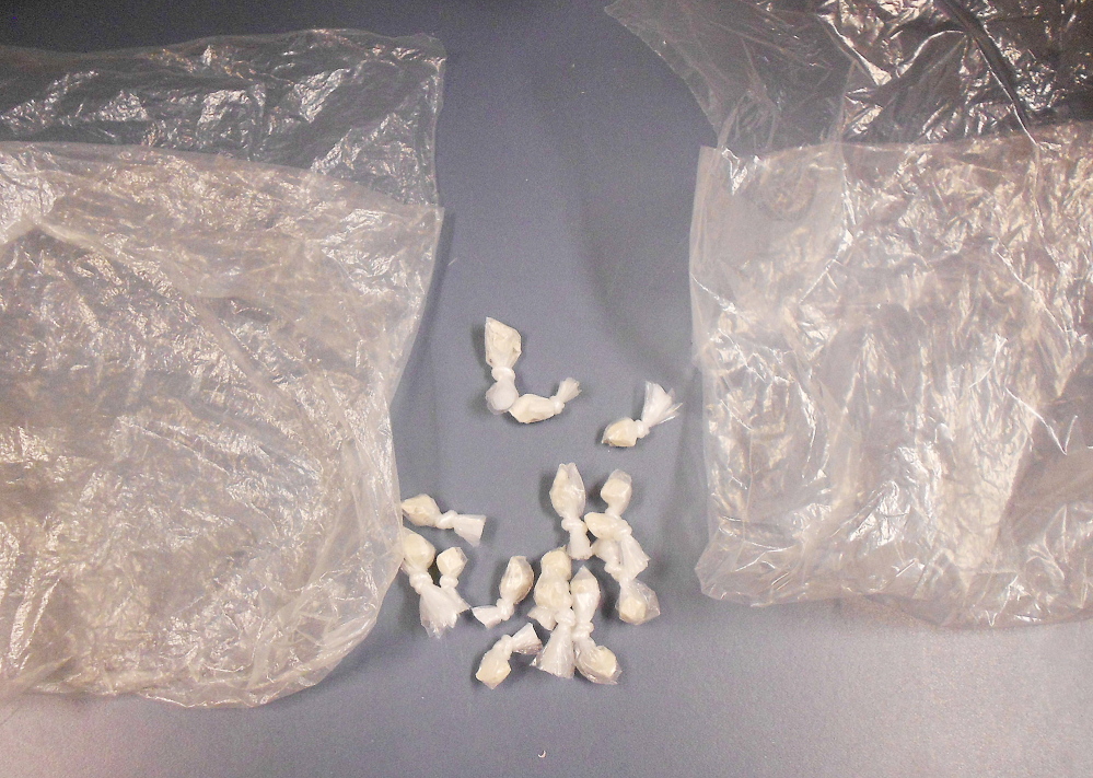 Police show what they say is heroin seized during an arrest Thursday. A Biddeford man is charged with trafficking.