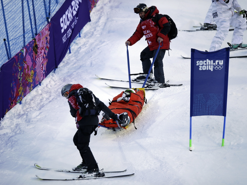 Heidi Kloser is stretchered off the course Thursday after crashing in a warmup run before qualifying in the women’s moguls at the Rosa Kutor Exreme Park ahead of the 2014 Winter Olympics in Krasnaya Polyana, Russia.
