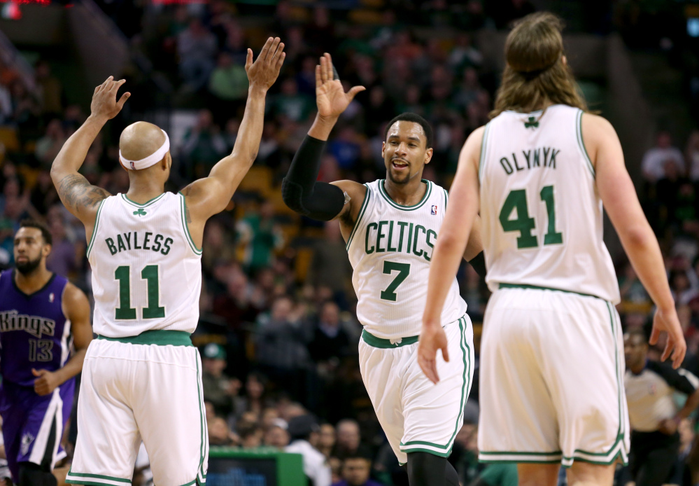 HIGH FIVE: Boston Celtics center Jared Sullinger (7) celebrates with teammates Jerryd Bayless (11) and Kelly Olynyk after scoring during the second half Friday against the Sacramento Kings in Boston. Sullinger scored 31 points and the Celtics won 99-89.