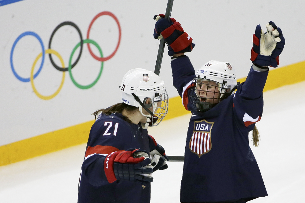 Kelli Stack of the Untied States celebrates her goal with teammate Hilary Knight during the second period of the 2014 Winter Olympics women’s hockey game against Finland at Shayba Arena on Saturday.