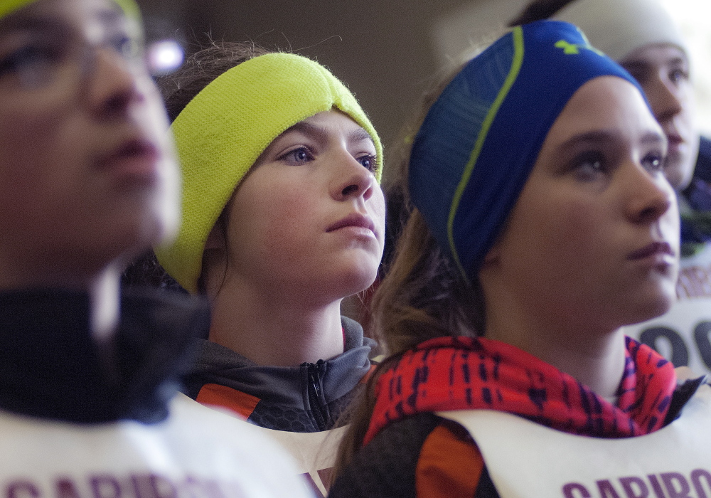 Caribou Middle School ski team members watch intently in Caribou on Saturday as the men's biathlon 10K sprint from Sochi, Russia, is live-streamed.