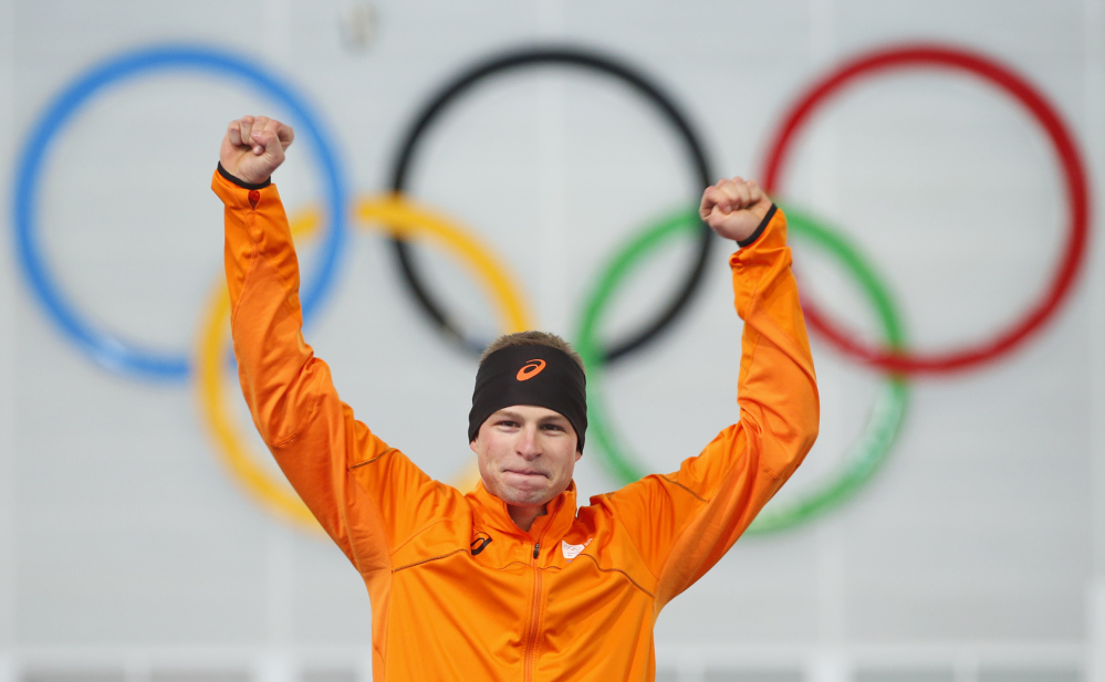 Sven Kramer of the Netherlands celebrates after winning the gold in the men’s 5,000-meter speedskating race during the flower ceremony at the Adler Arena Skating Center during the 2014 Winter Olympics in Sochi, Russia, on Saturday.