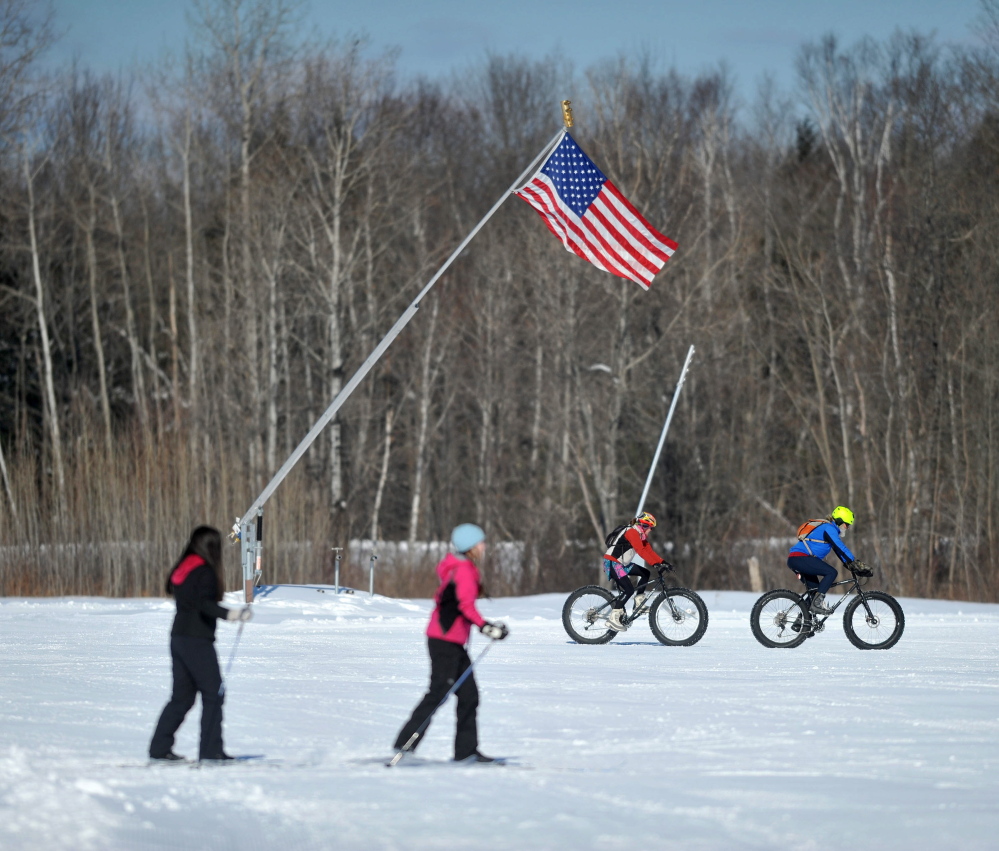 WINTER Fun: Snow mountain bikers and Nordic skiers shared the trail at Quarry Road Recreational Area in Waterville on Saturday during the annual Winter Carnival.